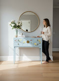 LIMS Legacy Singapore baby blue elm wood console table with brass hardware and floral bird motif. Features 4 drawers and 2 doors.