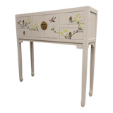 LIMS Legacy Singapore neutral console table with hand-painted birds and blossoms, brass hardware, and four drawers.