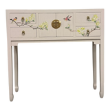LIMS Legacy Singapore light pink console table with hand-painted birds and blossoms, brass hardware, and four drawers.